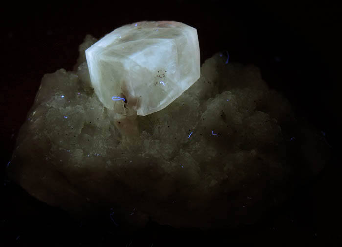 Photo below under longwave ultraviolet illumination of Calcite on Datolite with Pyrite from Millington Quarry, Bernards Township, Somerset County, New Jersey Calcite on Datolite with Pyrite from Millington Quarry, Bernards Township, Somerset County, New Jersey