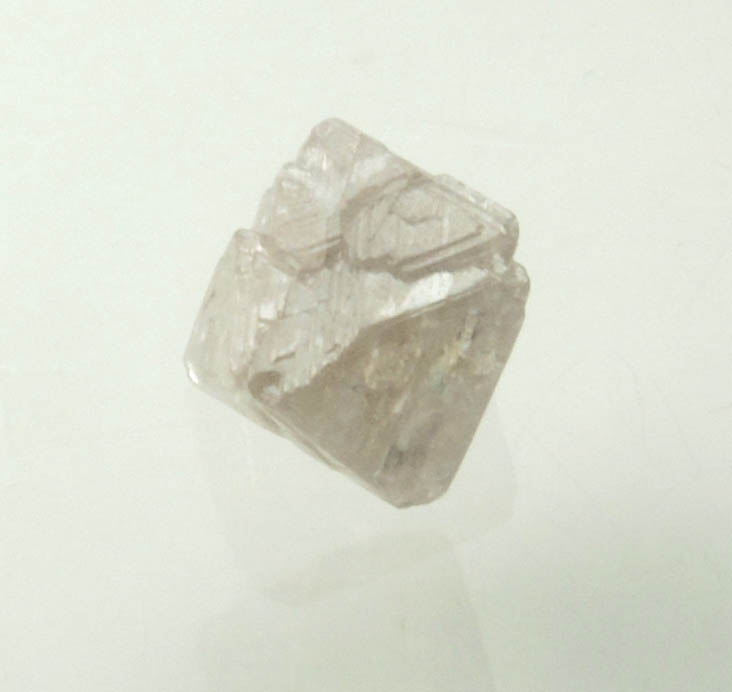 Diamond (0.70 carat pink-gray octahedral rough diamond) from Argyle Mine, Kimberley, Western Australia, Australia