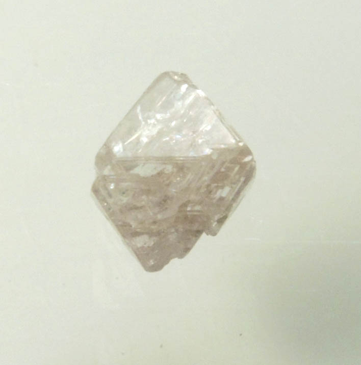 Diamond (0.70 carat pink-gray octahedral rough diamond) from Argyle Mine, Kimberley, Western Australia, Australia