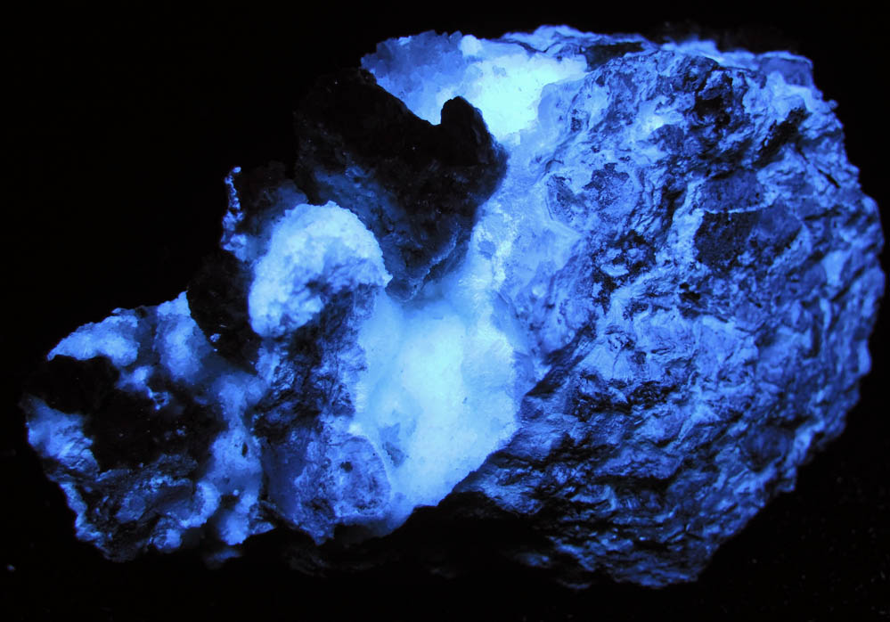 Photo below under shortwave ultraviolet illumination of Hydrozincite with Hemimorphite from Yellow Pine Mine, Goodsprings District, Clark County, Nevada Hydrozincite with Hemimorphite from Yellow Pine Mine, Goodsprings District, Clark County, Nevada