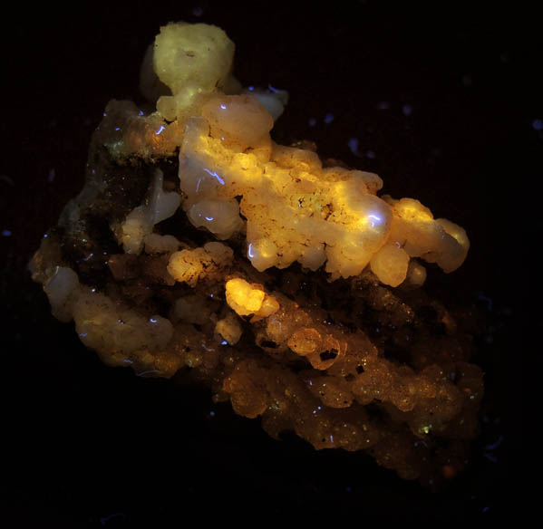 Photo below under longwave ultraviolet illumination of Datolite pseudomorphs after Anhydrite with Pyrite and Quartz var. Chalcedony from Millington Quarry, Bernards Township, Somerset County, New Jersey Datolite pseudomorphs after Anhydrite with Pyrite and Quartz var. Chalcedony from Millington Quarry, Bernards Township, Somerset County, New Jersey