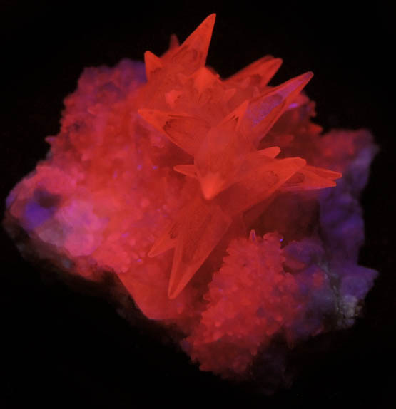 Photo below under shortwave ultraviolet illumination of Calcite with phantom-growth zoning from Millington Quarry, Bernards Township, Somerset County, New Jersey Calcite with phantom-growth zoning from Millington Quarry, Bernards Township, Somerset County, New Jersey