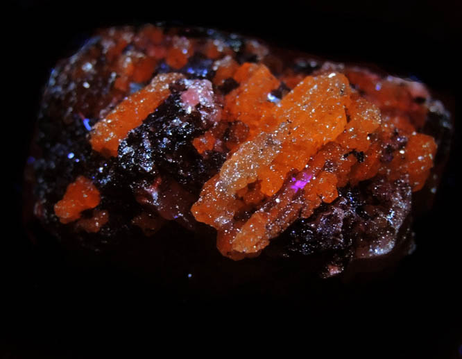Photo below under longwave ultraviolet illumination of Grossular var. Tsavorite Garnet (unusual linear compound crystals) from Merelani Hills, near Arusha, Tanzania Grossular var. Tsavorite Garnet (unusual linear compound crystals) from Merelani Hills, near Arusha, Tanzania
