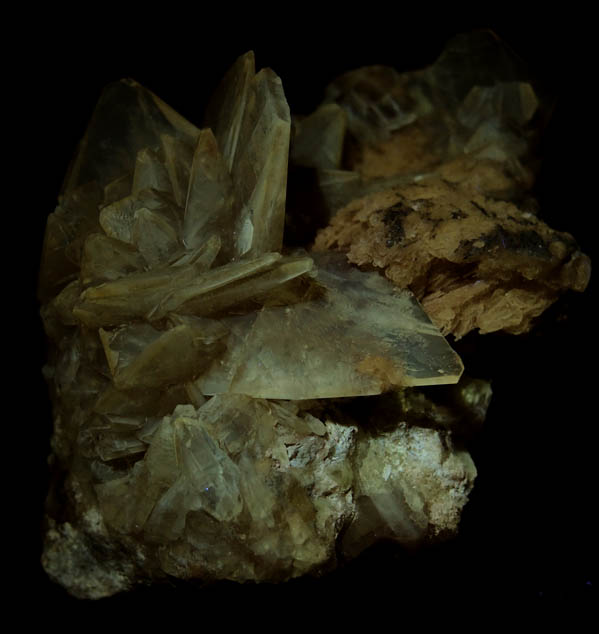 Photo below under longwave ultraviolet illumination of Colemanite from Kramer Deposit, Boron, Kern County, California Colemanite from Kramer Deposit, Boron, Kern County, California