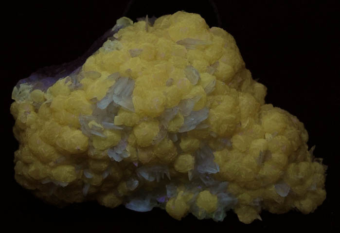 Photo below under shortwave ultraviolet illumination of Calcite over Colemanite from Kramer Deposit, Boron, Kern County, California Calcite over Colemanite from Kramer Deposit, Boron, Kern County, California