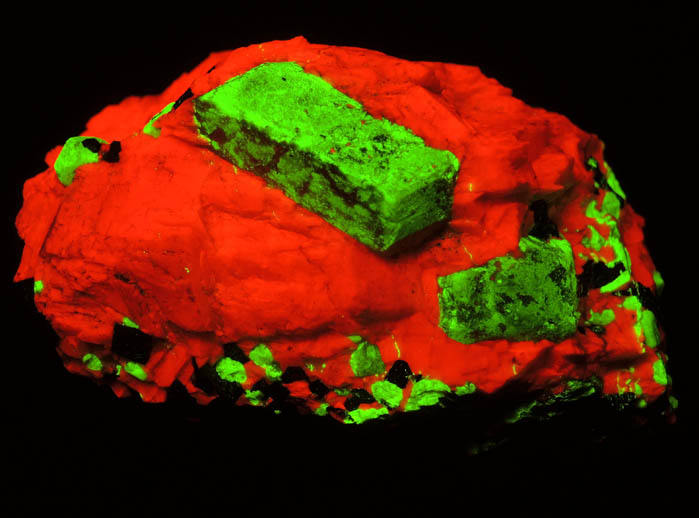 Photo below under shortwave ultraviolet illumination of Willemite in Calcite with Franklinite from Sterling Mine, Ogdensburg, Sterling Hill, Sussex County, New Jersey (Type Locality for Franklinite) Willemite in Calcite with Franklinite from Sterling Mine, Ogdensburg, Sterling Hill, Sussex County, New Jersey (Type Locality for Franklinite)