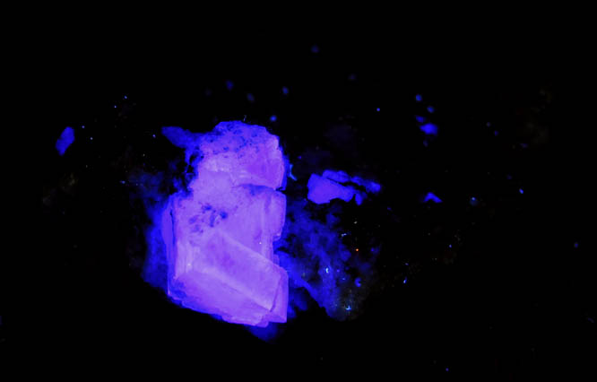 Photo below under longwave ultraviolet illumination of Fluorite on Calcite from Old Mine Plaza, Trumbull, Fairfield County, Connecticut Fluorite on Calcite from Old Mine Plaza, Trumbull, Fairfield County, Connecticut